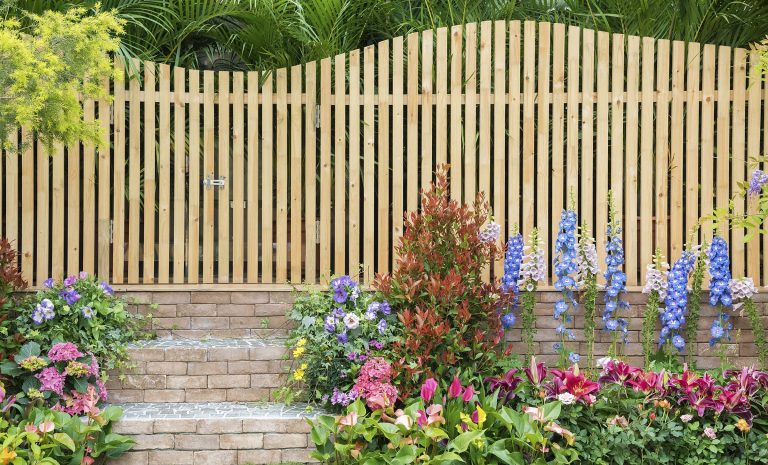 Wooden fence with flowers and landscaping
